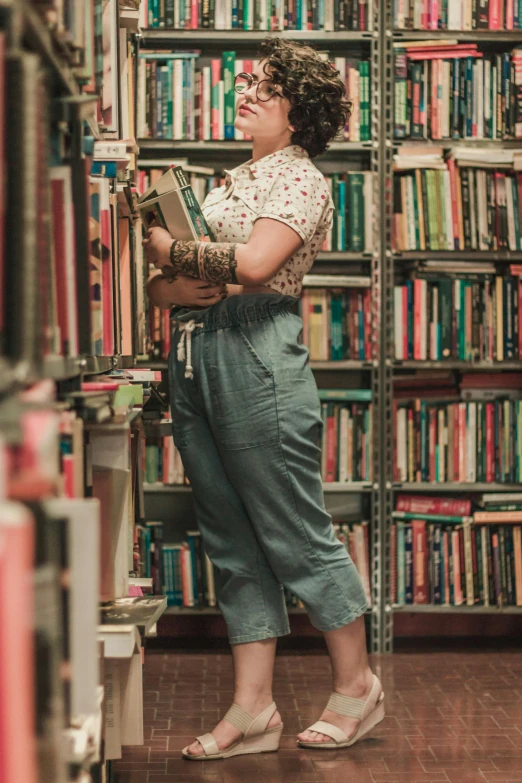 a woman in glasses stands behind a book shelf and looks up at the sky