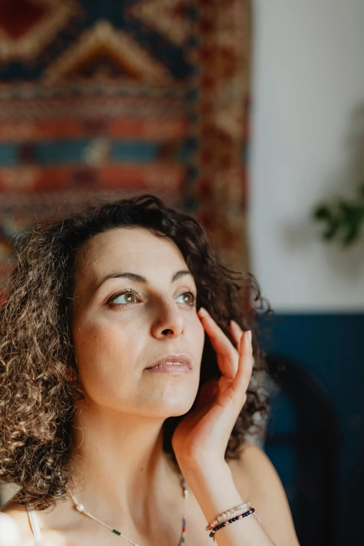 the woman with curly hair is staring intently