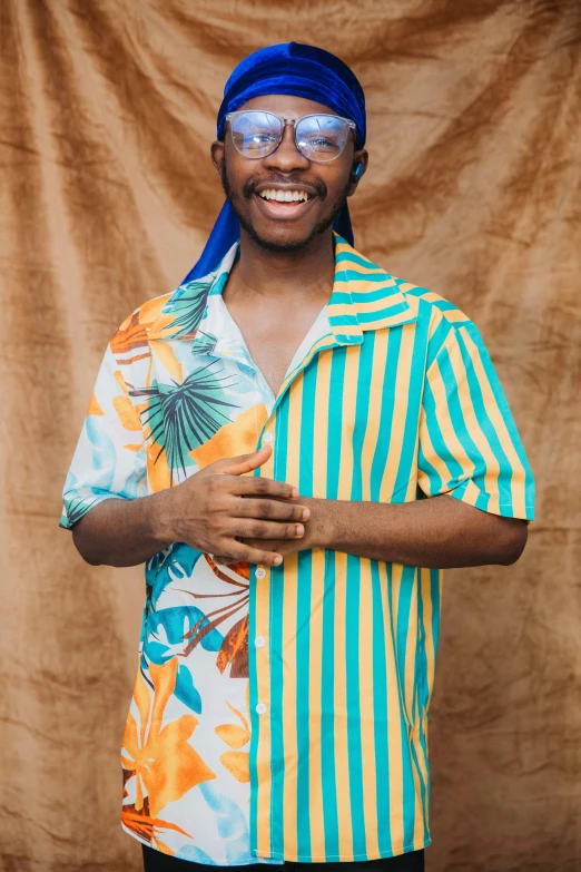 a man that is wearing glasses and a colorful shirt