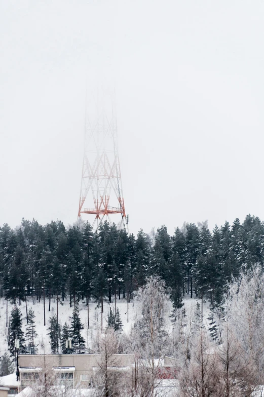 a cell phone tower on top of a snow covered mountain