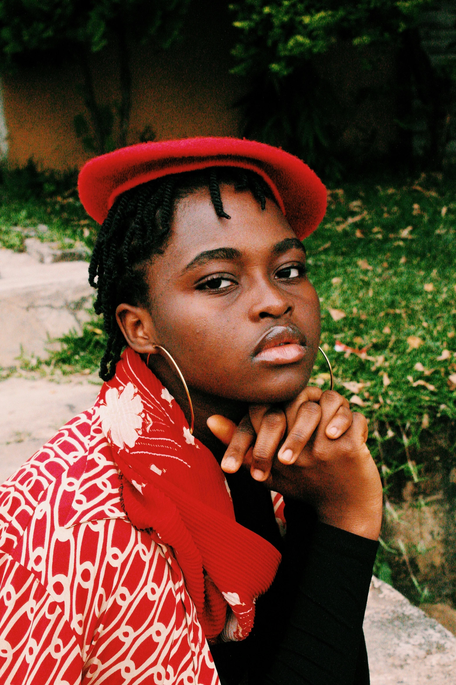 a woman wearing a red hat is posing