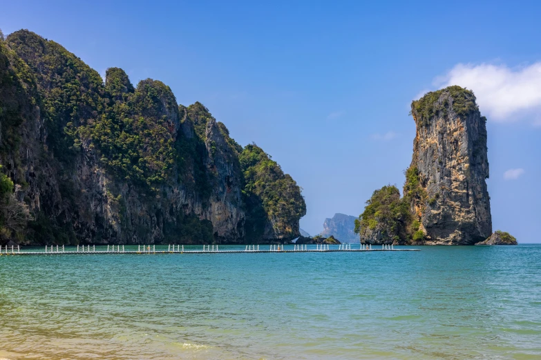 the large mountains are on the beach near water