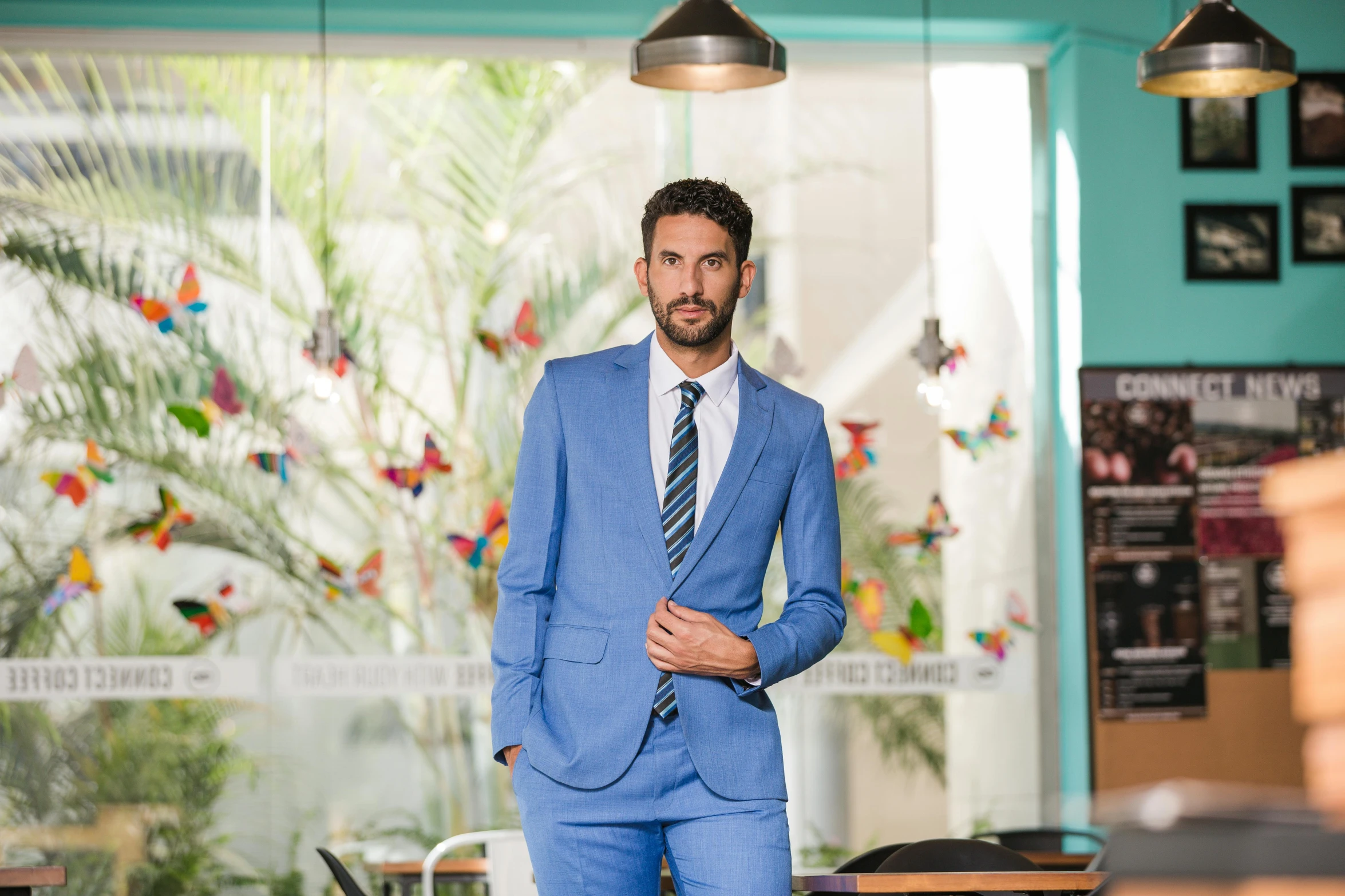 a man in a suit in the middle of a room