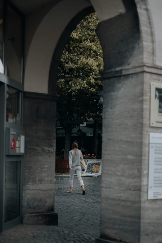 a man in white is walking down the street