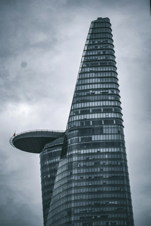 a very tall building with some sort of flying object in front