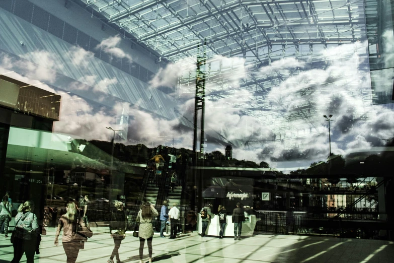 a reflection of people inside a building with many windows