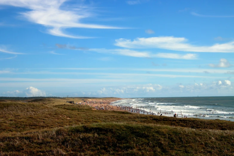 some people are standing at the edge of a beach