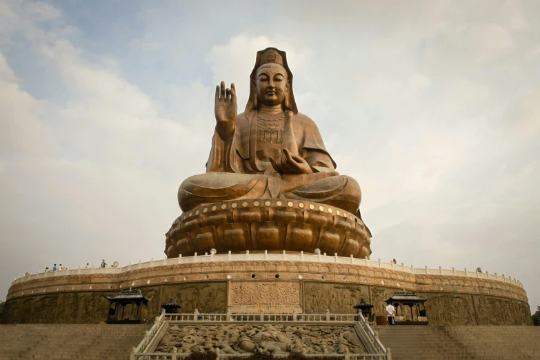 a huge statue in the shape of a person is seen