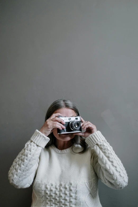 woman holding a camera to take a self portrait