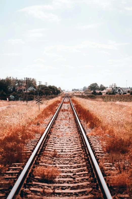 an empty train track is shown in the middle of the day