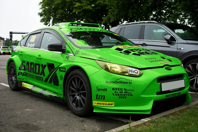 a green subarundant parked in front of two other cars