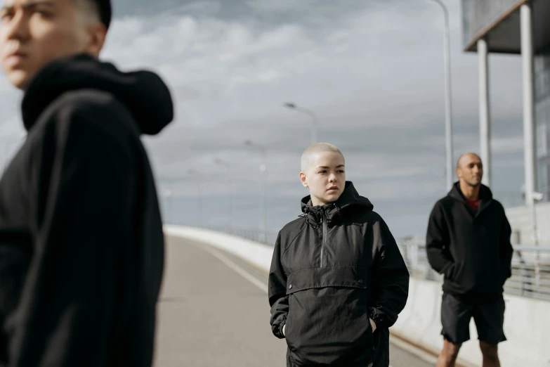 a man in black is standing outside with another man