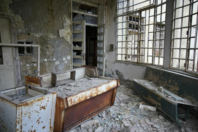 the old sinks in the bathroom are surrounded by window panes