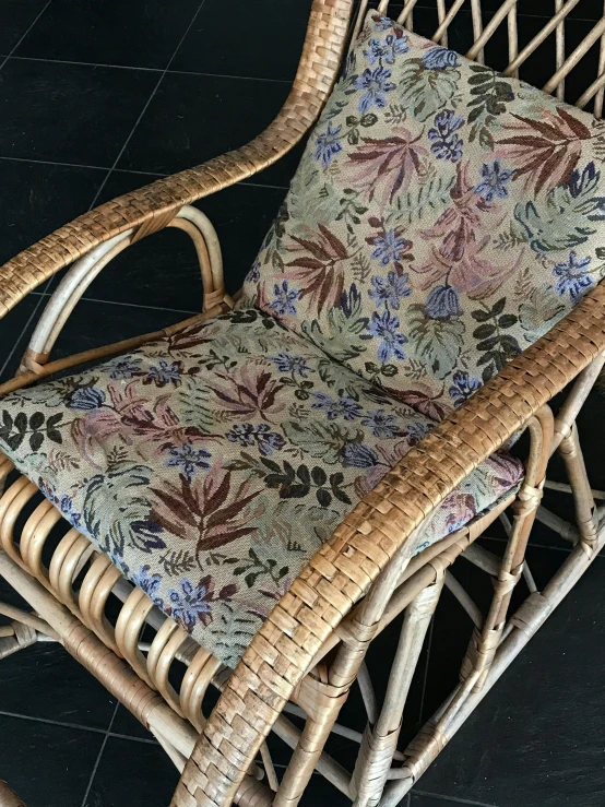 an elegant rat chair with a floral fabric cover