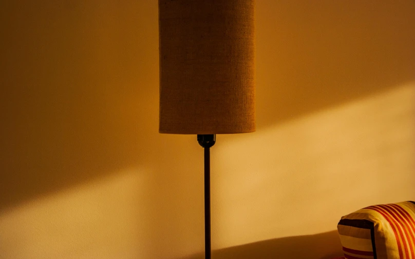 a lamp on a wooden stand in a room