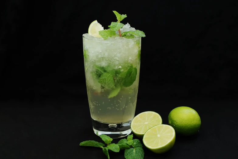 a glass filled with green lemon and mint