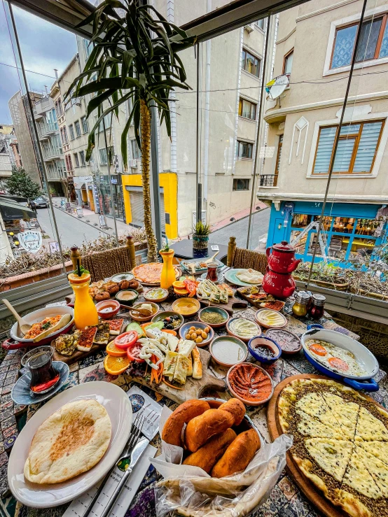 an outdoor buffet table with plates of food