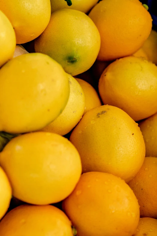 a large pile of lemons that are yellow and brown