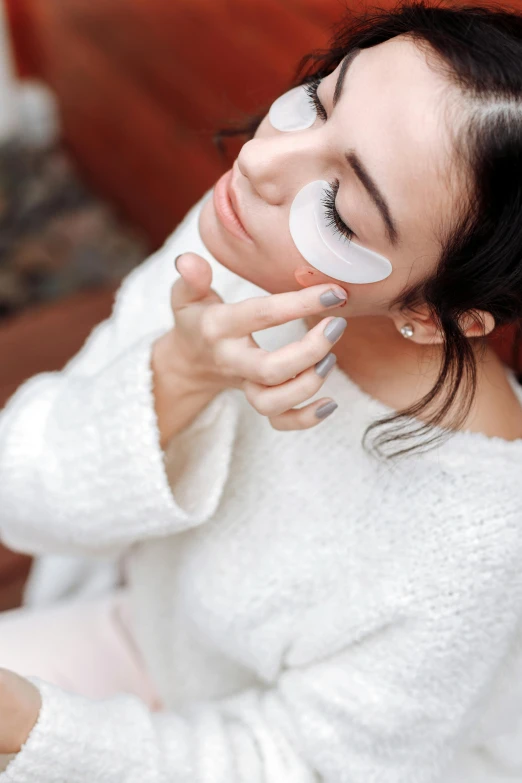 woman with makeup applied to her face using the power mirror