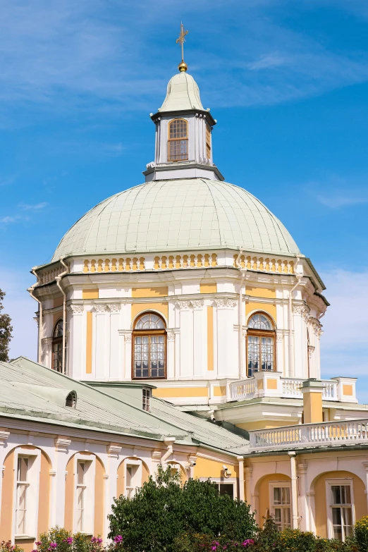 the dome on the building has many windows and a cross on top