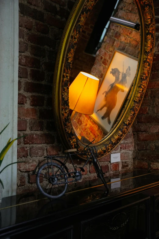 a table with a bicycle sitting underneath a mirror