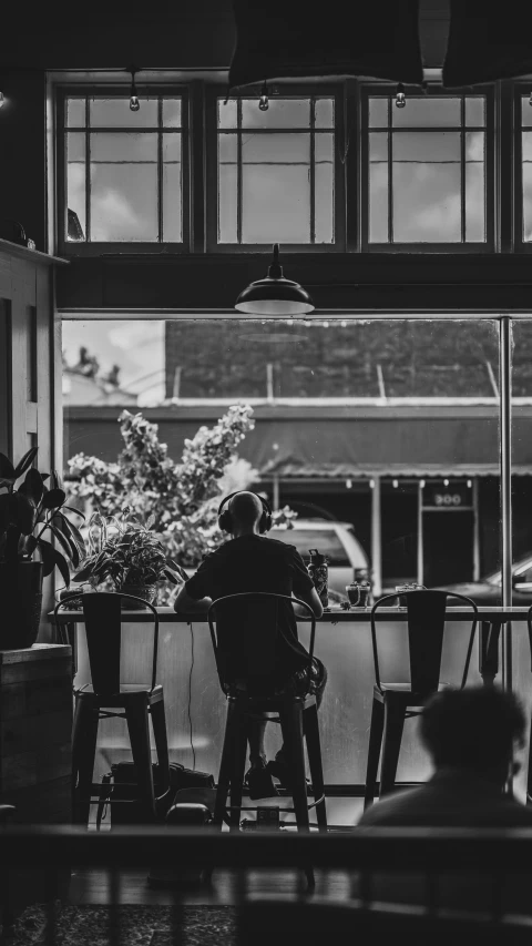 a man in a chair looking out the window