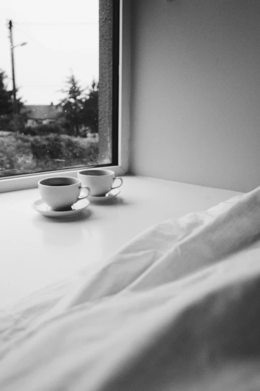 a black and white po of teacups on a desk