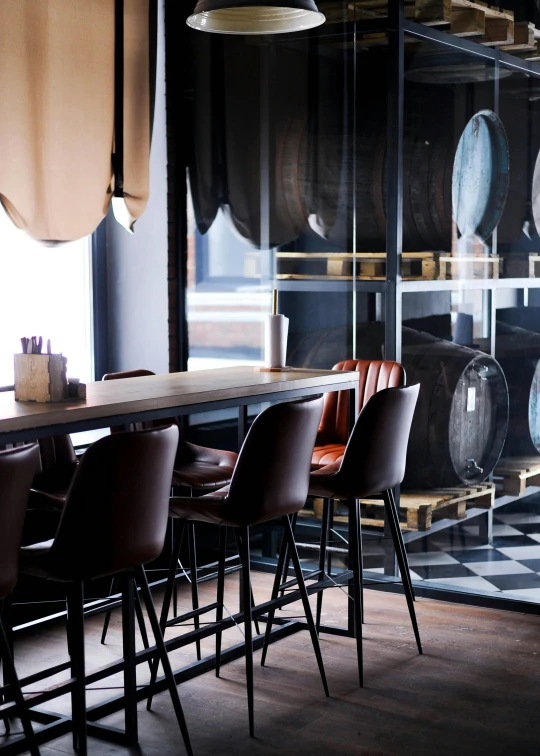 some brown chairs are sitting at a table in a room