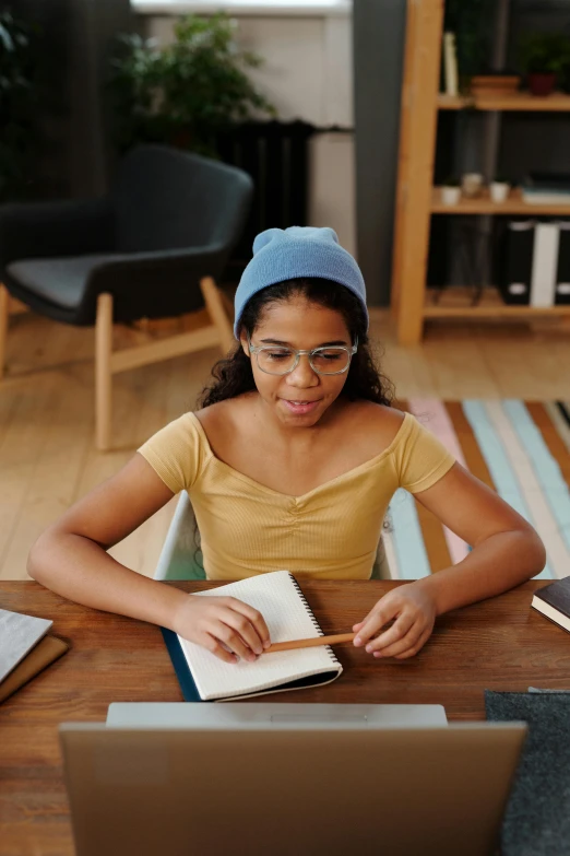 a  sits at a desk with an open book