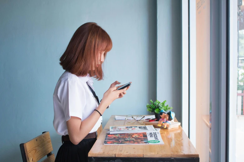 woman using a cell phone at the table