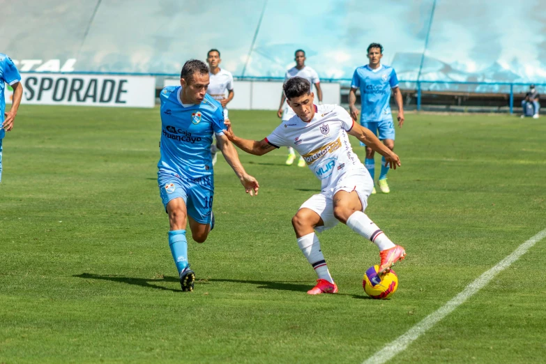 a group of men playing soccer on a green field