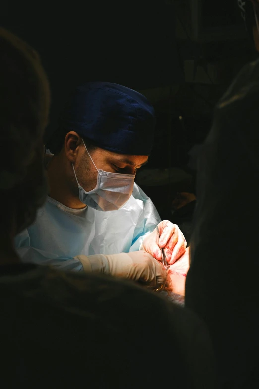 a man is at a  procedure and looking down