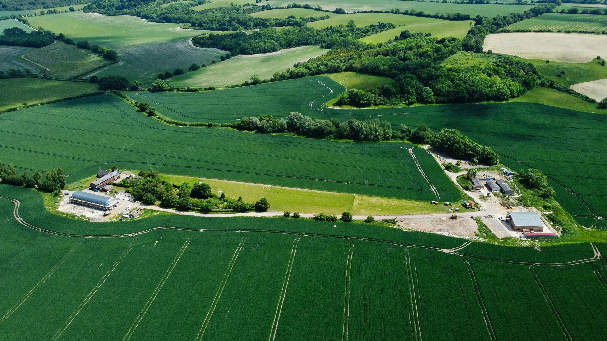 an aerial view of farmland fields and houses in rural countryside