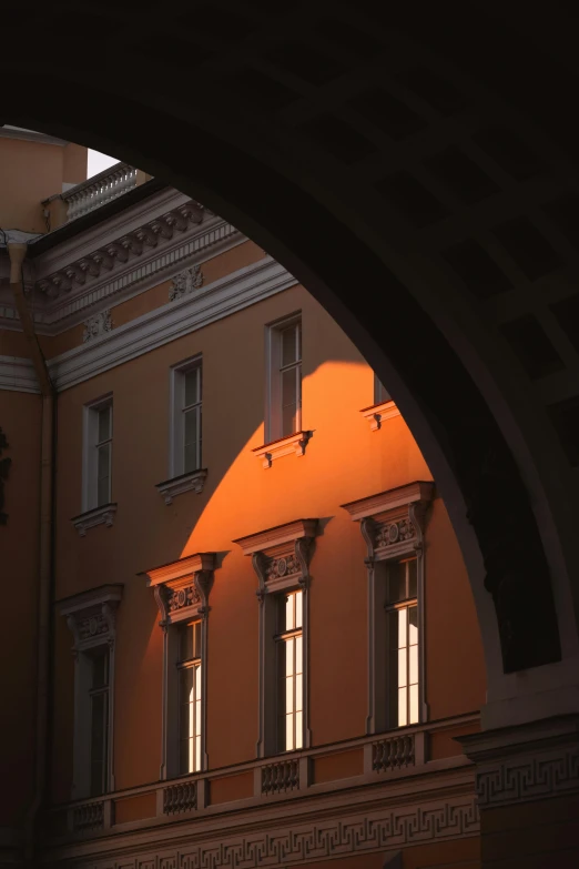 an orange light is in the windows of some buildings