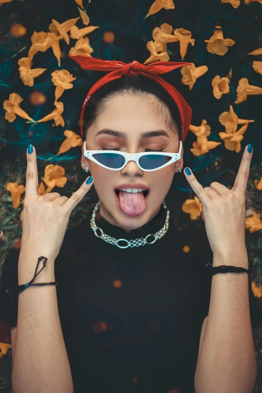 a woman with sunglasses sticking her tongue out