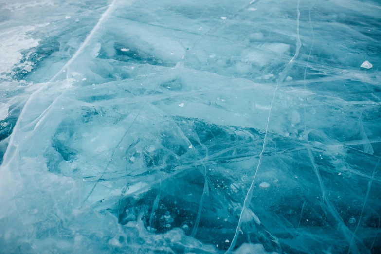 an aerial view of ice crystals in blue water