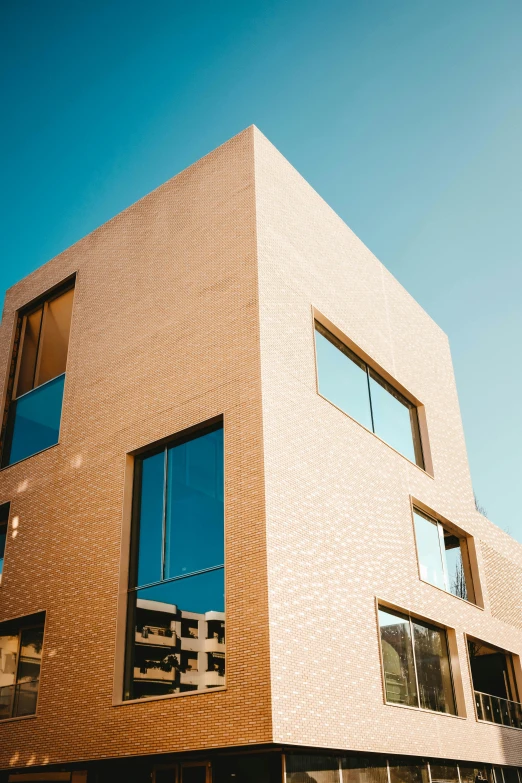 the front of a large brown building against a blue sky