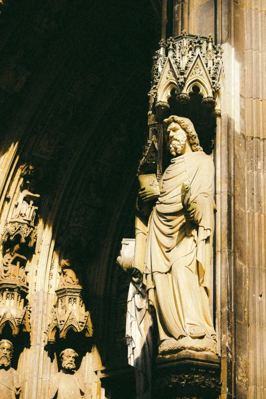 a stone sculpture next to a cathedral doorway