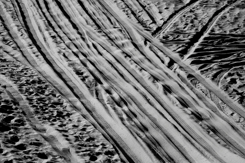 a couple of jeeps driving across the snow covered ground