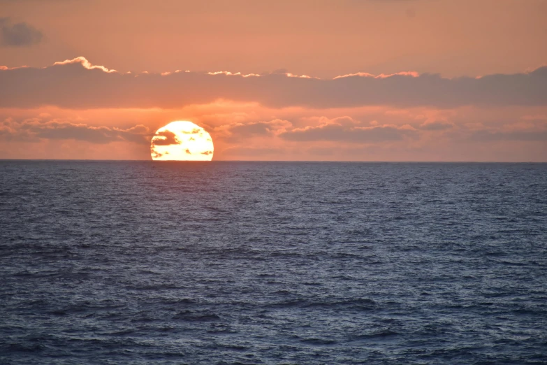 a sunrise in the middle of a body of water