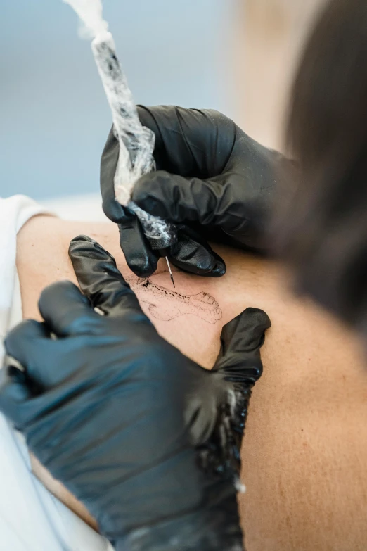 a person with gloved hands operating an iv