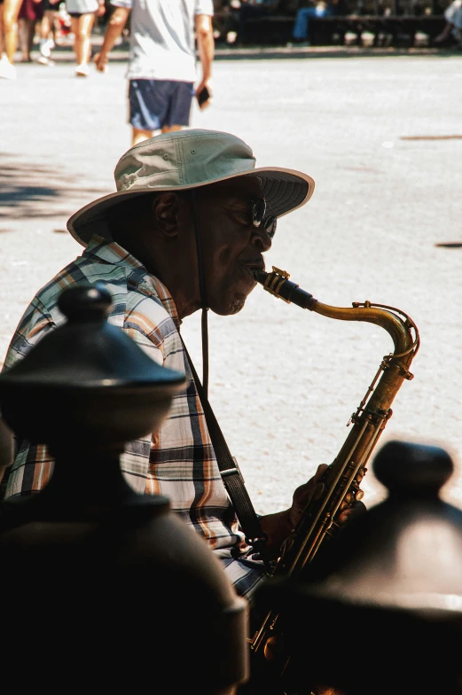 the man is playing on the saxophone in the street