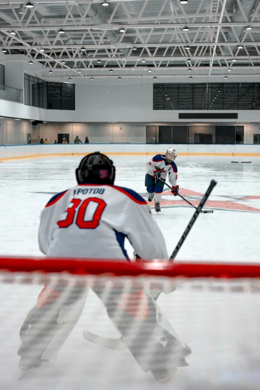 a hockey player waiting for the goalie to return