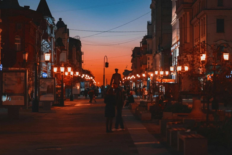 the man is walking down the city street at night