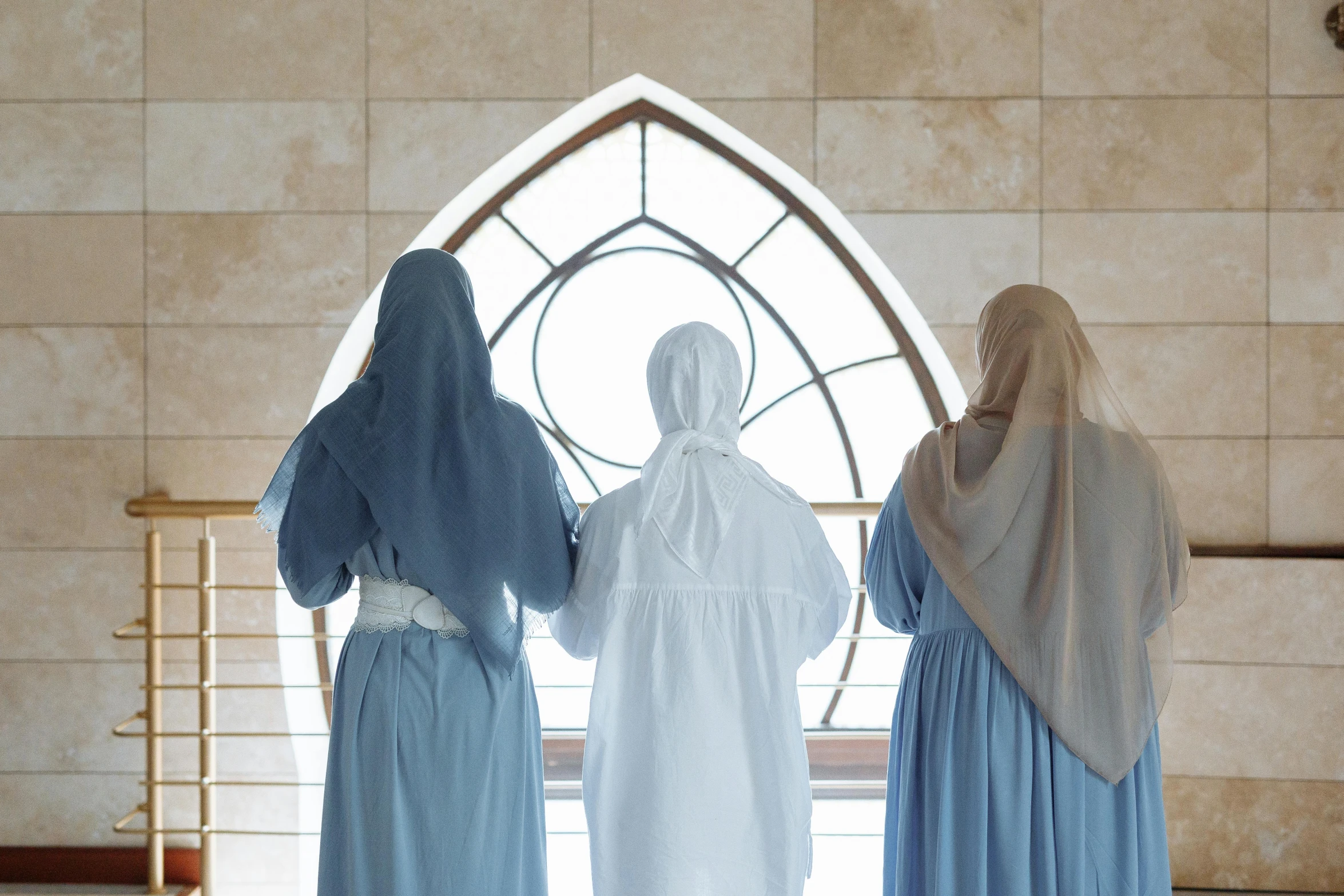 three mannequins and two women standing in a church