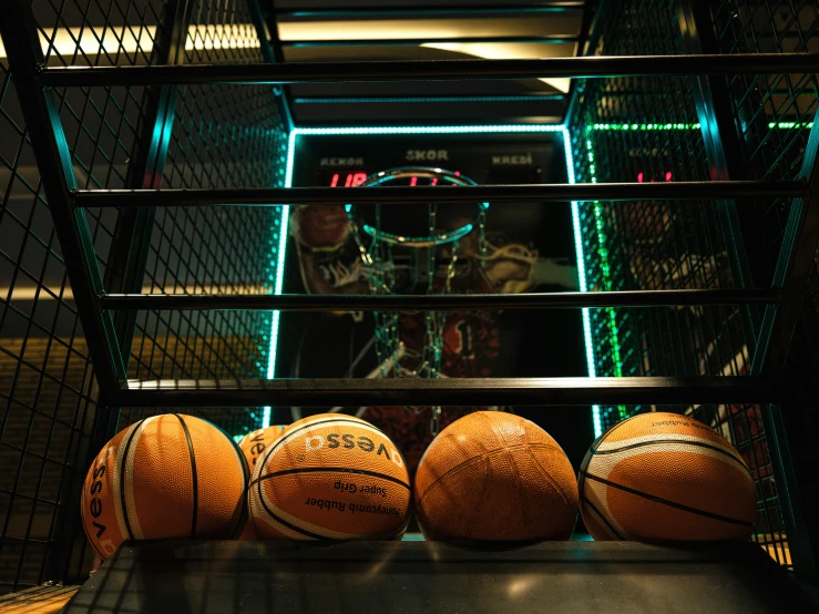 a rack with a basketballs in it in the middle of an indoor area