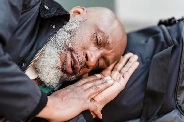 a man sleeping while wearing a jacket