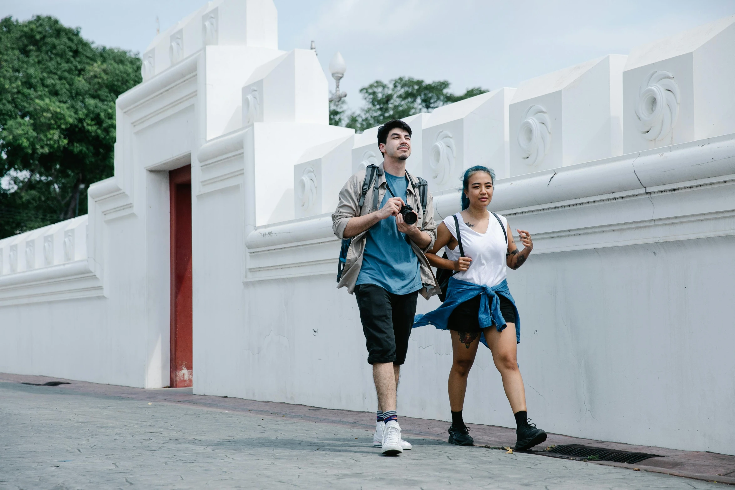 two people are walking in a half - circle together