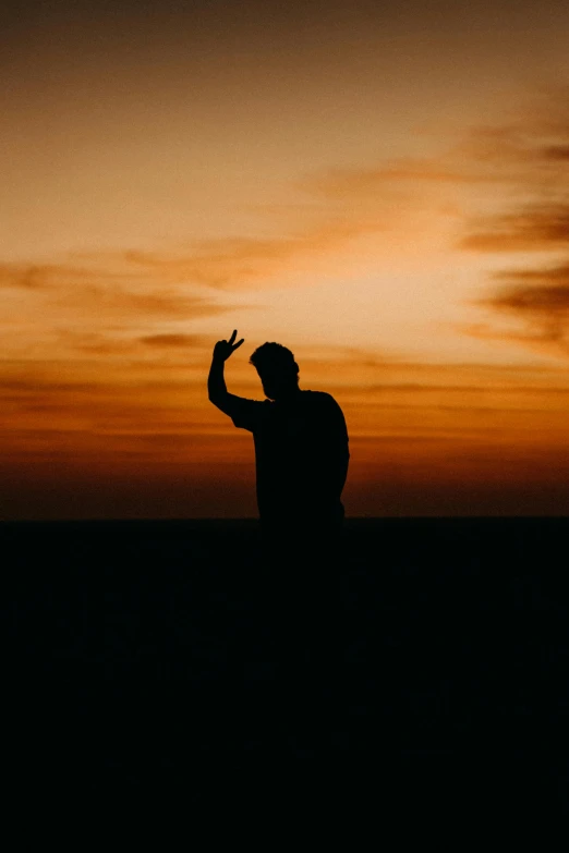 the silhouette of a man in black and orange is pictured