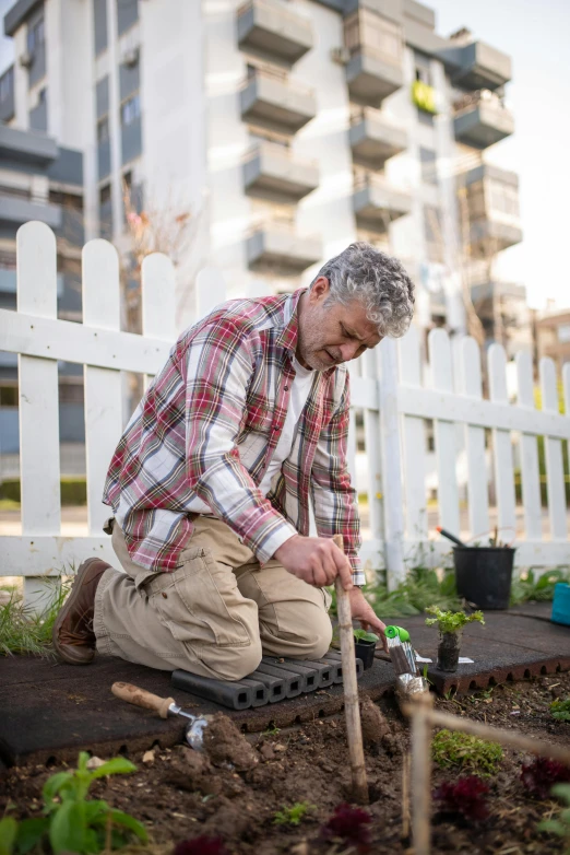 the man is taking care of his plants